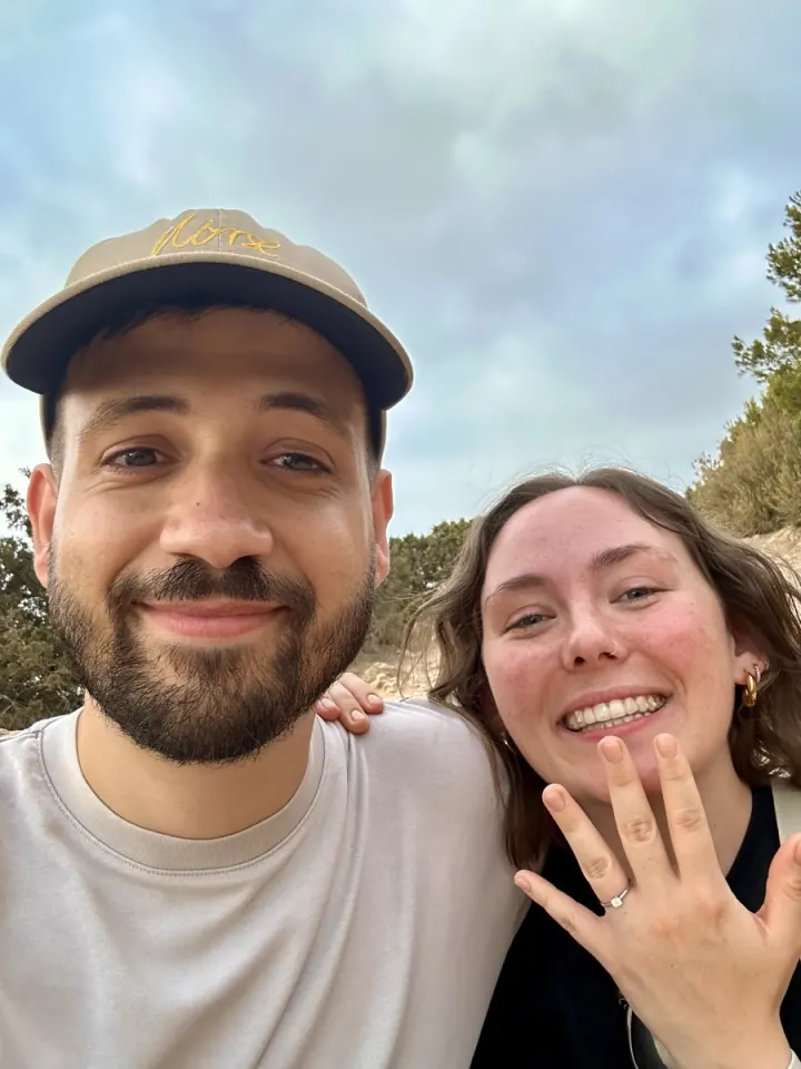Chloe and Pol smiling together and showing their engagement ring